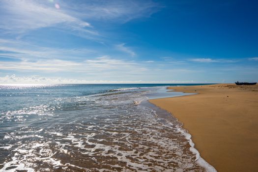 Serene view of Batticaloa beach with golden sands and blue skies in Sri Lanka.