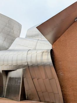 A striking blend of modern architecture featuring metallic and brick facades.