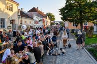 Lively outdoor dining event on a summer evening in Kuressaare, Estonia, showcasing local culture.