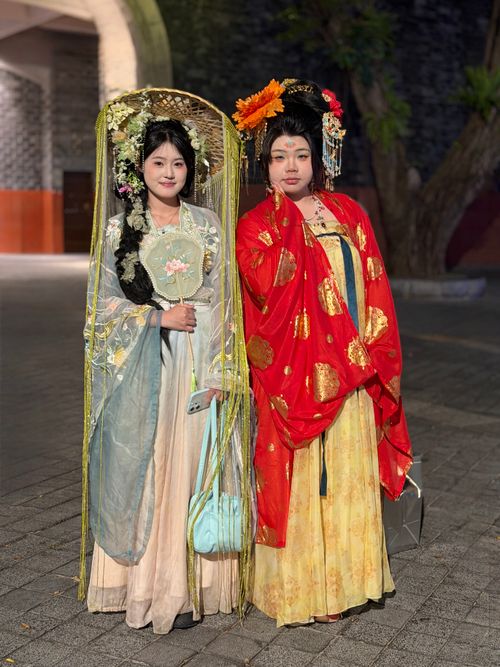 Free Two women in traditional Chinese costumes posing at night in Guangzhou, China. Stock Photo