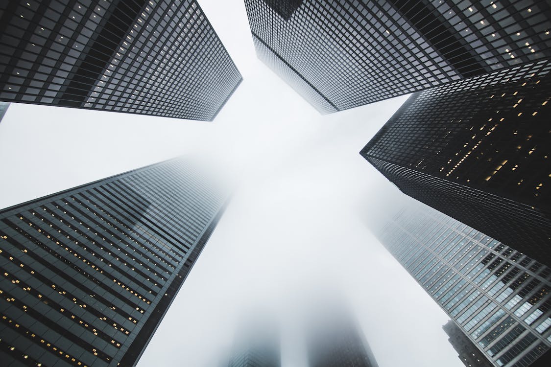 Free Low-angle Photography of Buildings Covered by Fog Stock Photo