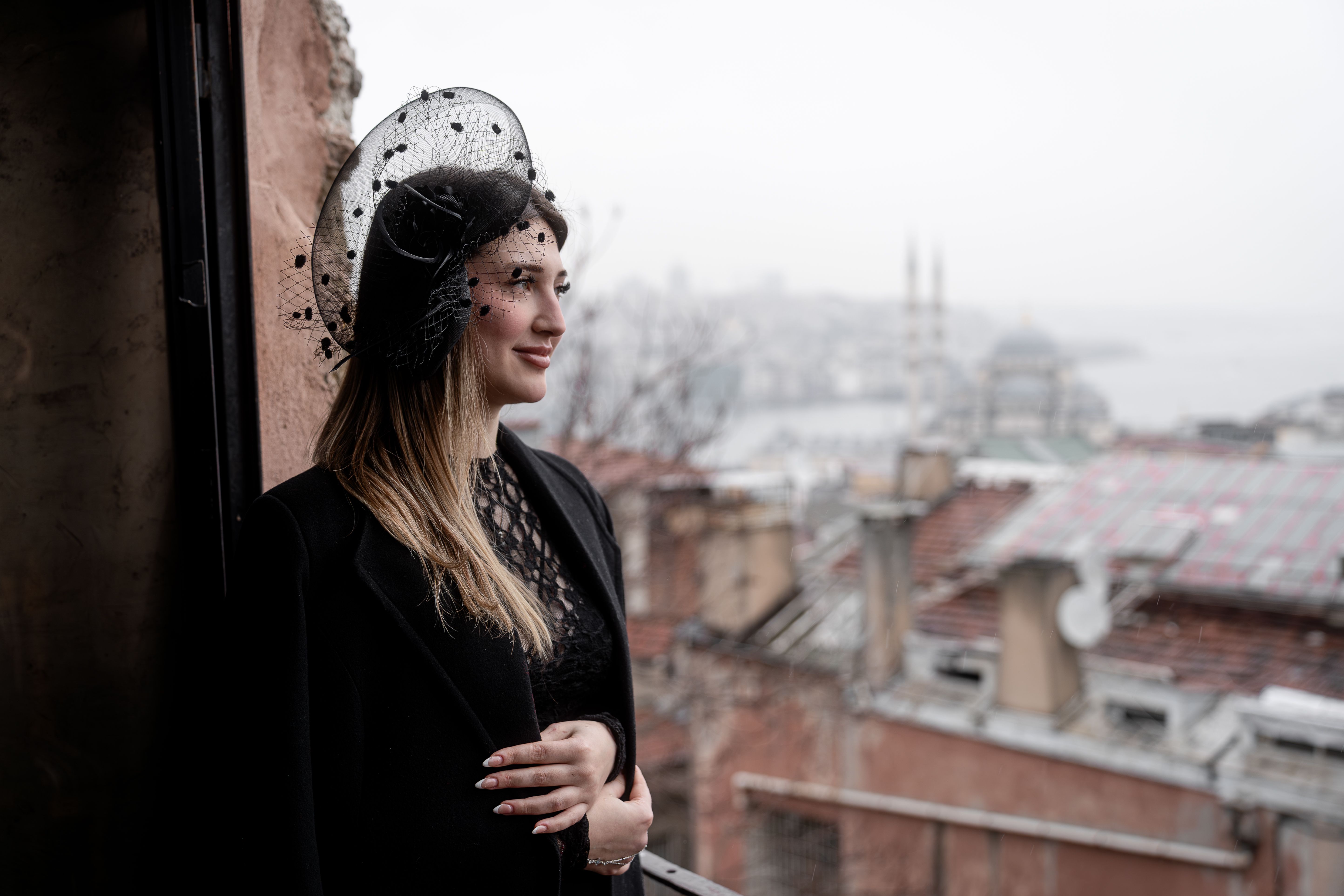 A woman in an elegant fascinator — occasion dressing for Royal Ascot, a summer wedding or the races.