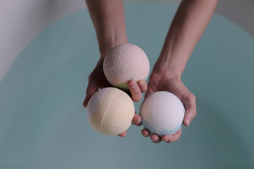 Person Holding Three Bath Bombs