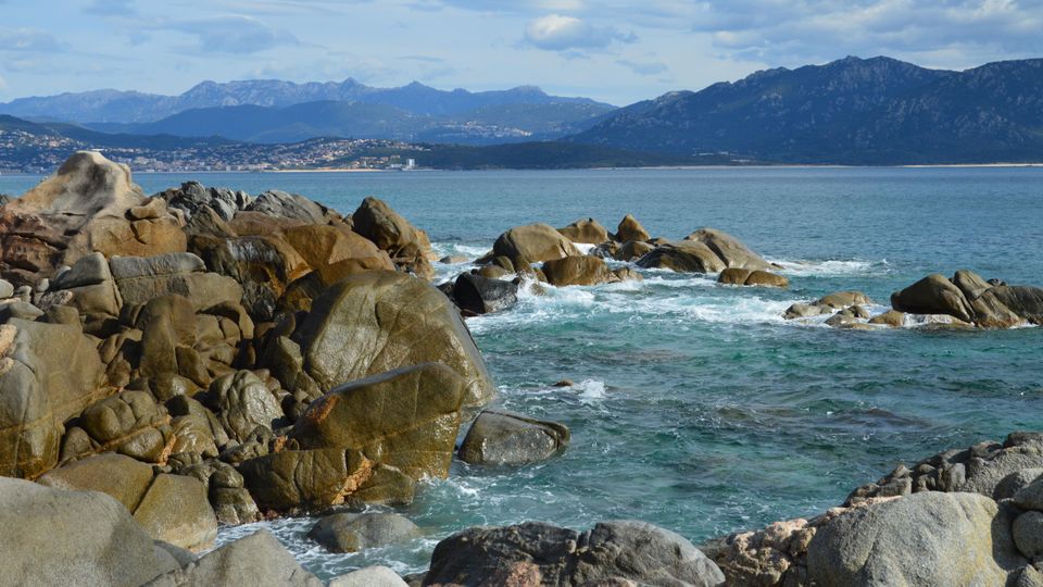Granite headland and turquoise cove in Corsica
