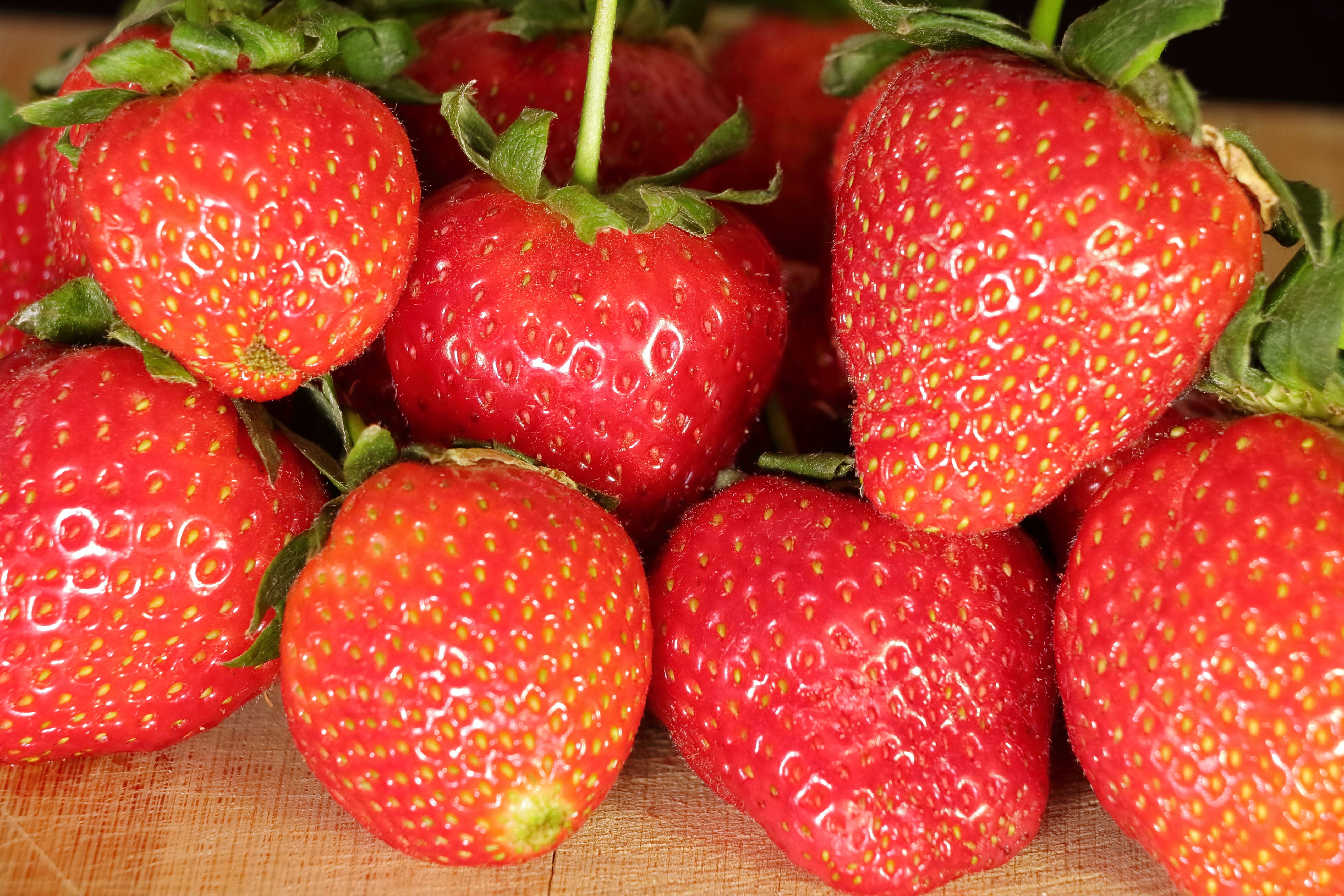 Fresh whole strawberries in a shallow container lined with paper towel
