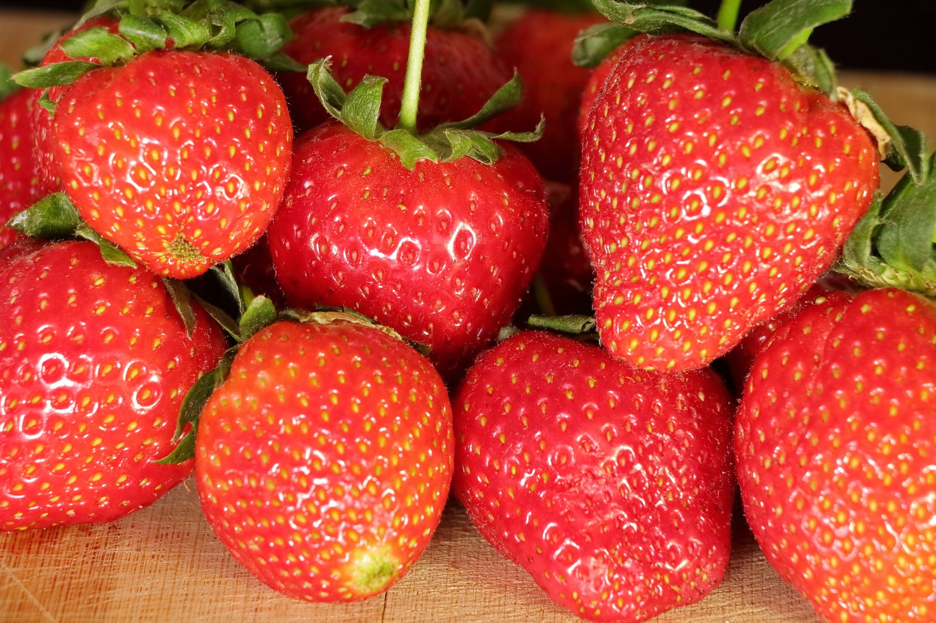Fresh whole strawberries in a shallow container lined with paper towel