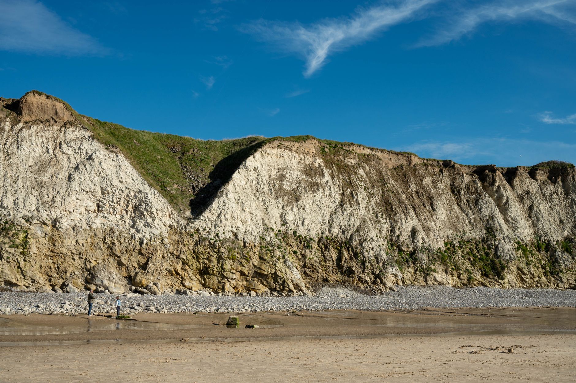Majestic chalk cliffs under a blue sky at Escalles Beach, Hauts-de-France, France.