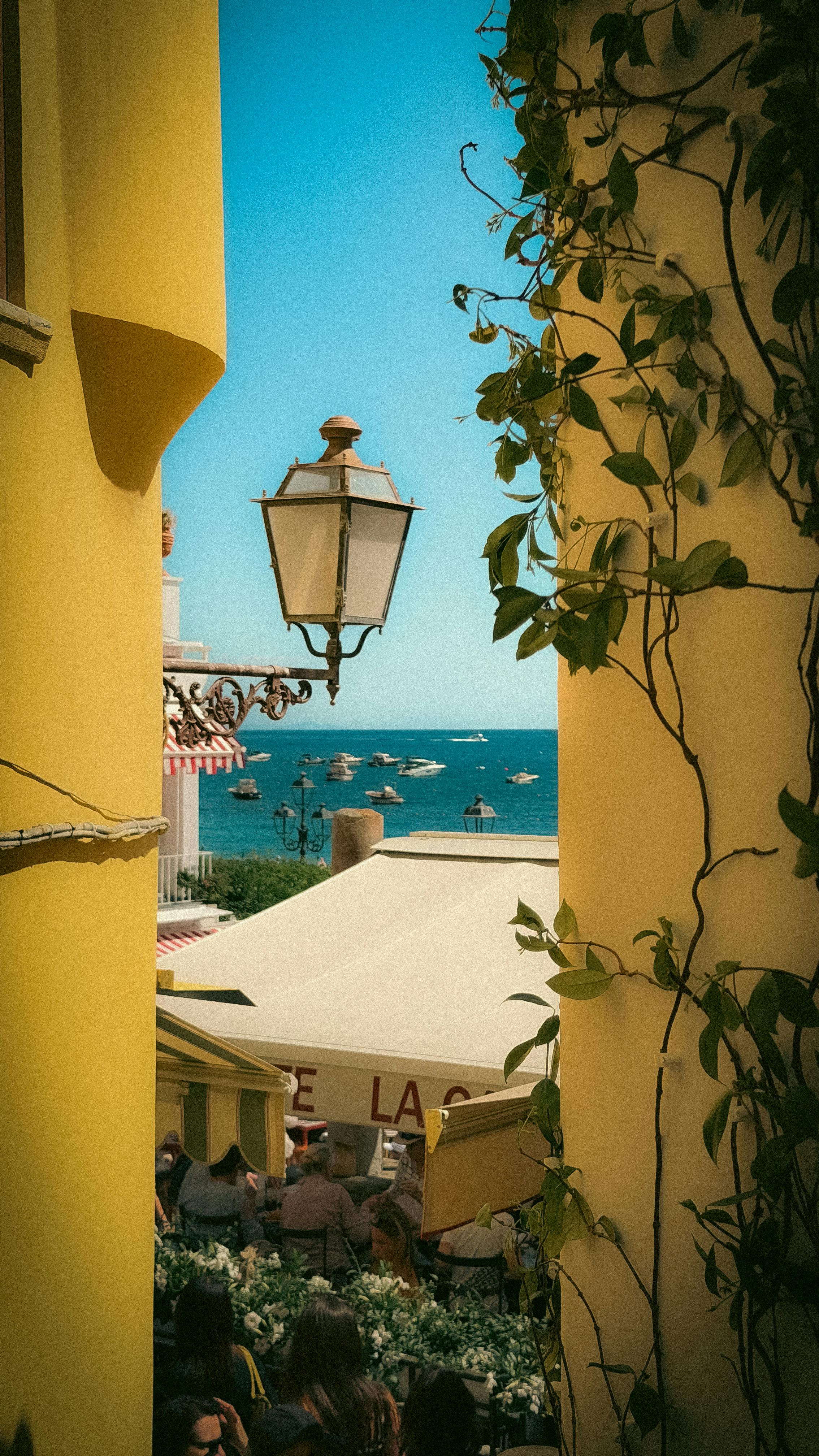 A charming coastal view through a vibrant alley on the Amalfi Coast
