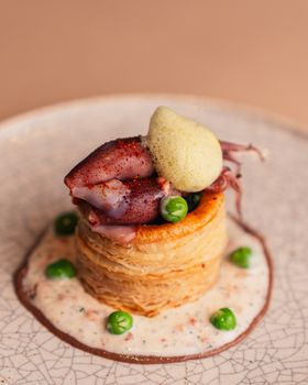 Artistic presentation of a gourmet squid tartlet with pea foam in Tokyo.