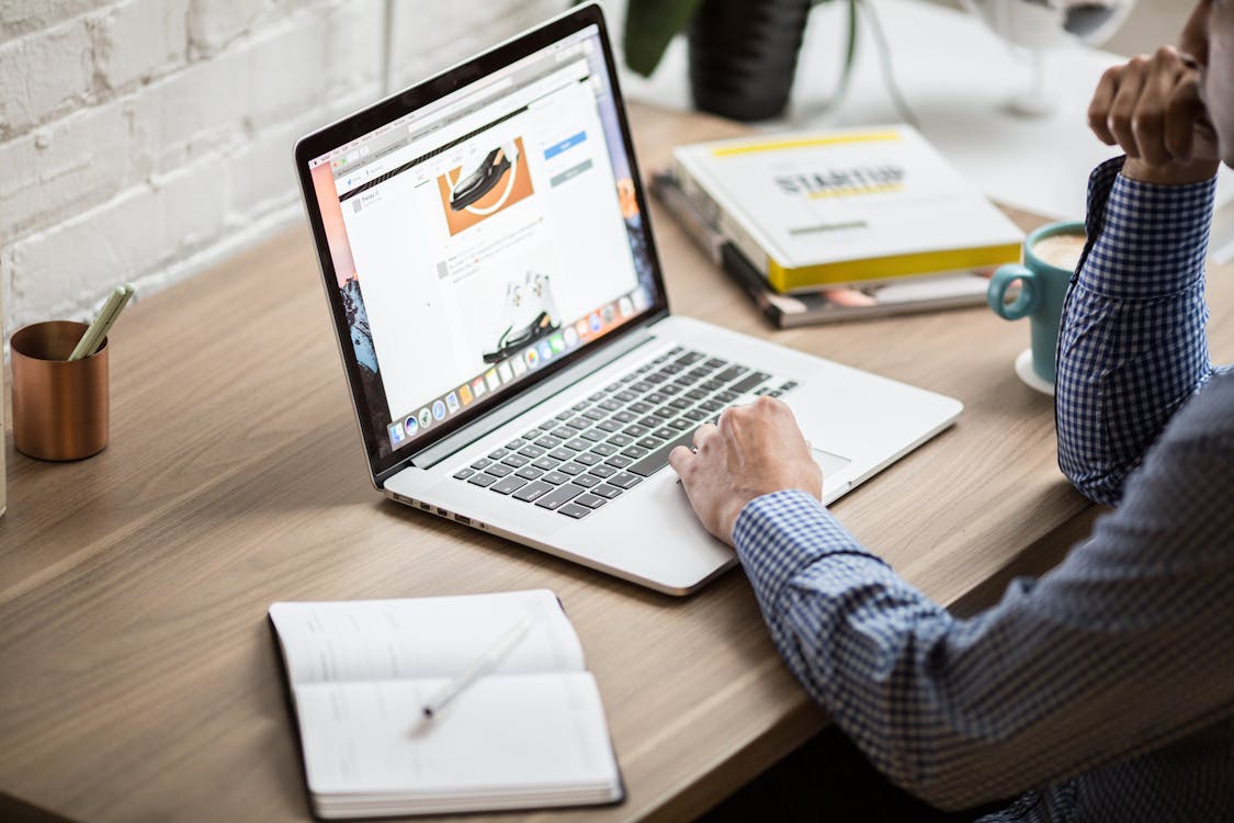 Person Using Laptop Computer Assessing a Website