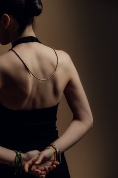 Rear view of a woman in black dress emphasizing elegance and simplicity.