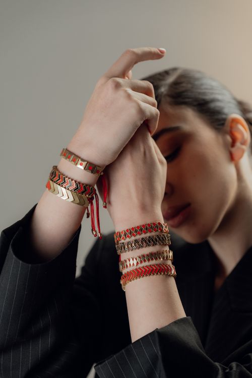 Free Close-up portrait of a woman wearing fashionable bracelets with a contemplative pose. Stock Photo
