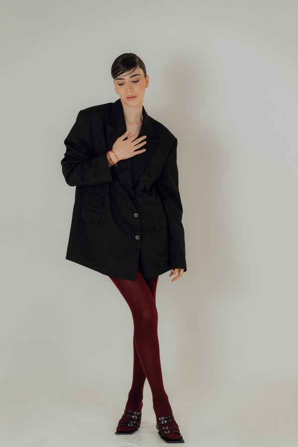 Woman wearing a burgundy midi dress with a blazer