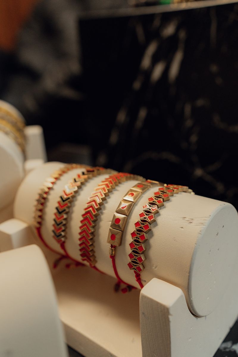 Gold and red bracelets on display
