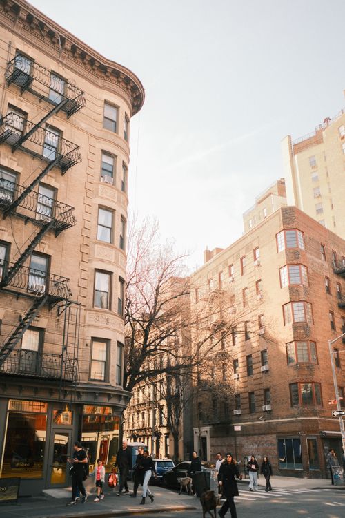 Free Street view of historic buildings in downtown New York City, bustling with people on a sunny day. Stock Photo
