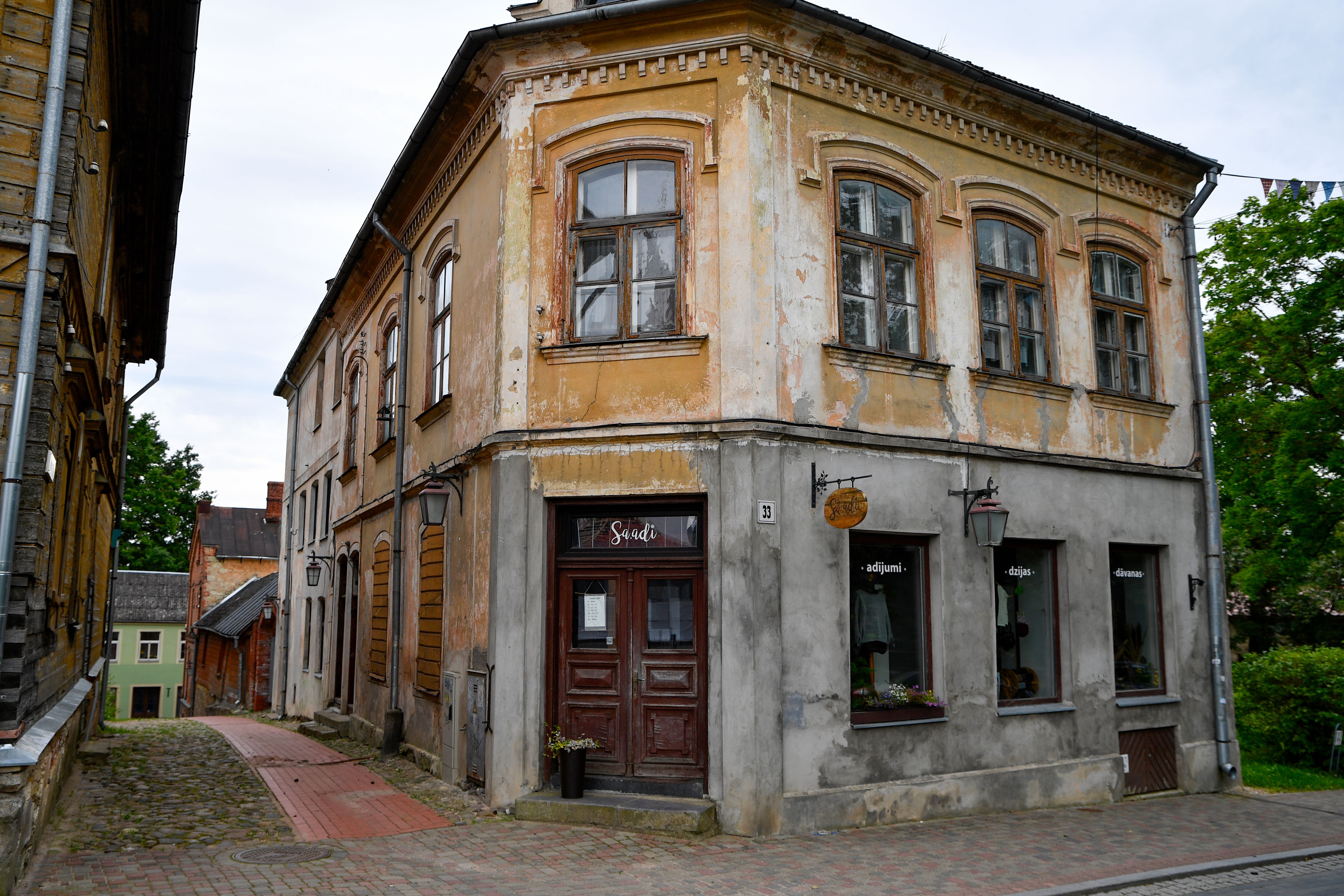 Explore the enchanting charm of a historic building on a cobblestone street in Cēsis, Latvia.