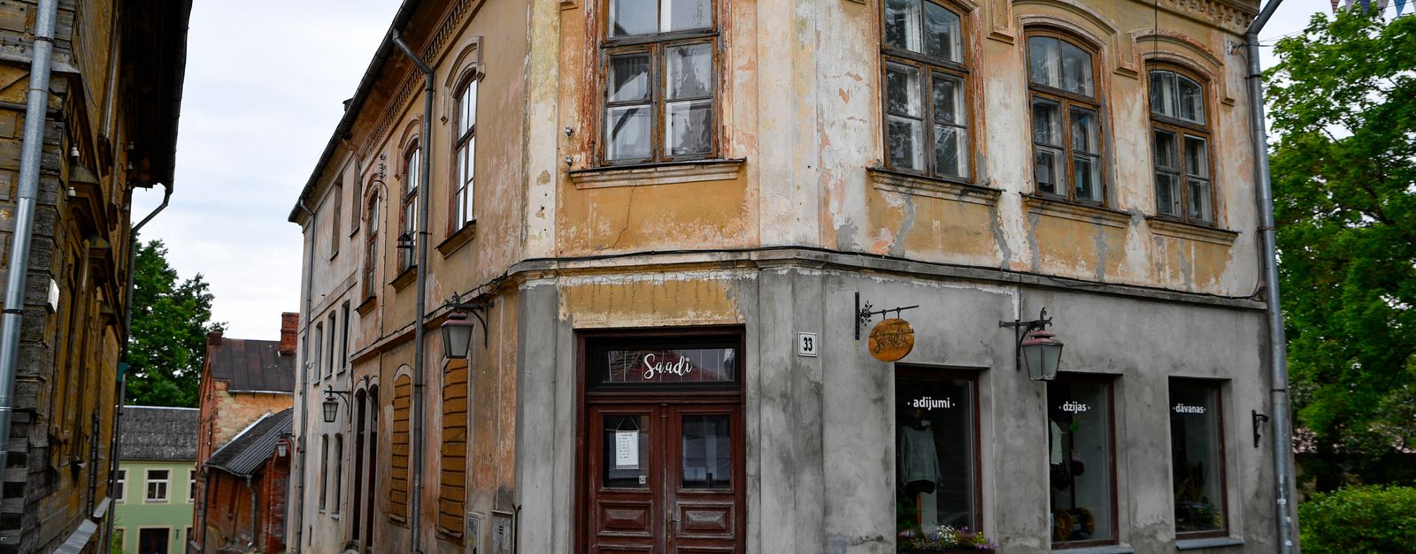 Explore the enchanting charm of a historic building on a cobblestone street in Cēsis, Latvia.