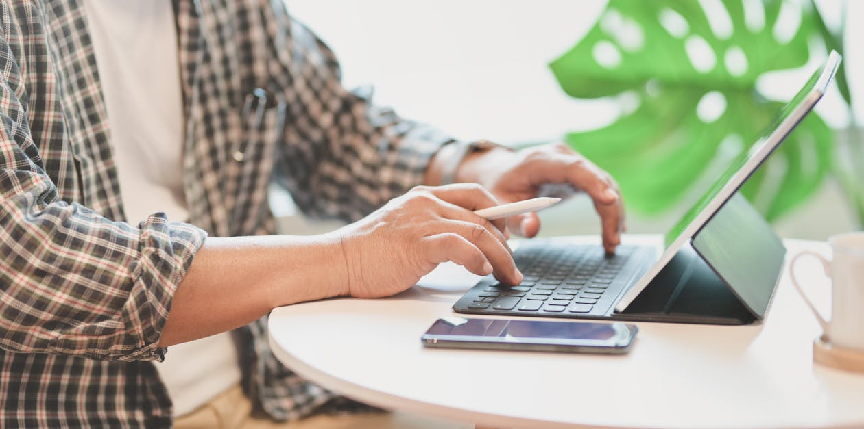 Person Using Macbook on Table