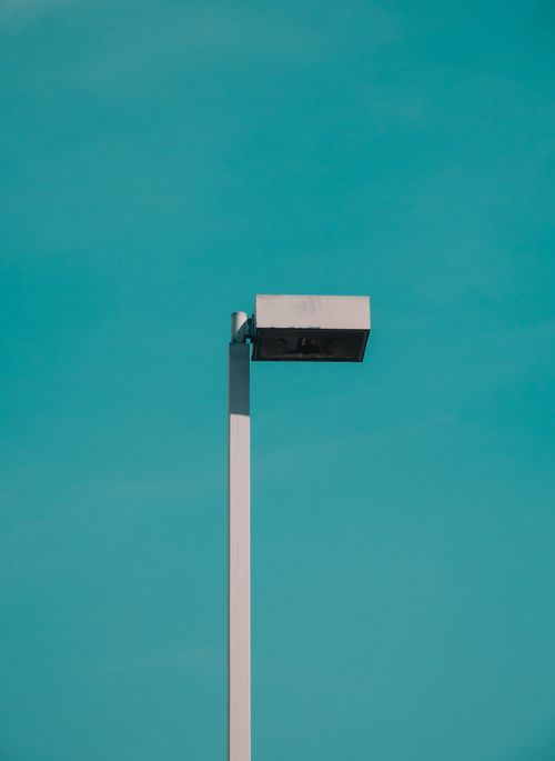 Free A lone streetlight stands against a vibrant blue sky, symbolizing solitude and minimalism. Stock Photo