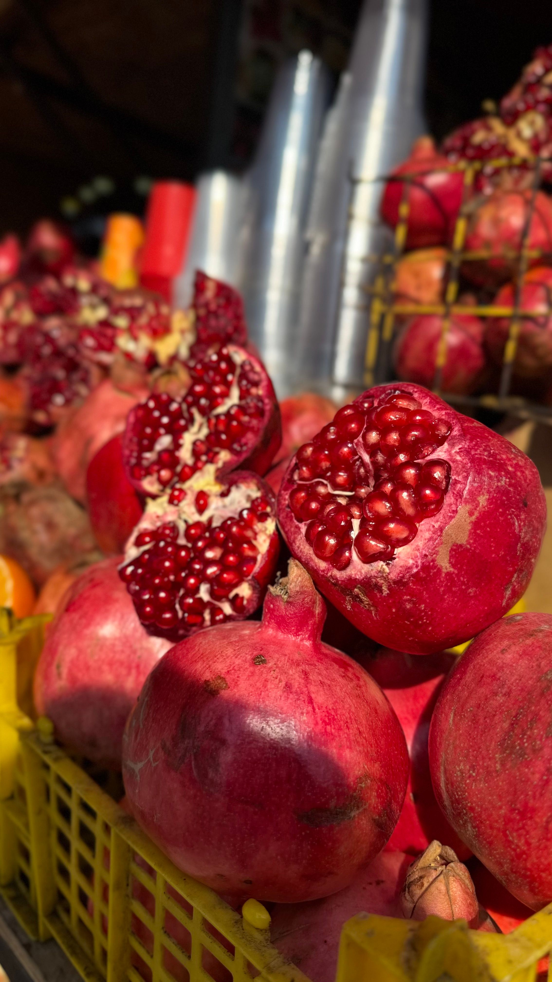 Vibrant and fresh pomegranates displayed in a market, capturing their rich color and texture.