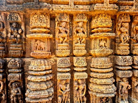 Detailed view of ancient stone carvings showcasing skilled craftsmanship on a historic temple wall.