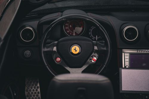 Free Close-up view of a luxurious sports car steering wheel and dashboard with classic design elements. Stock Photo