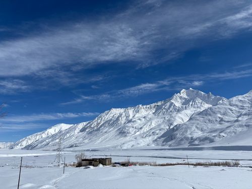 Free Breathtaking view of snow-covered mountains under a blue sky in Ladakh, India. Stock Photo