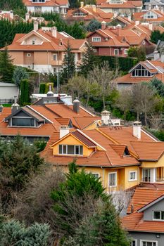 Scenic view of red-roofed houses surrounded by lush greenery in Ankara, showcasing urban architecture.