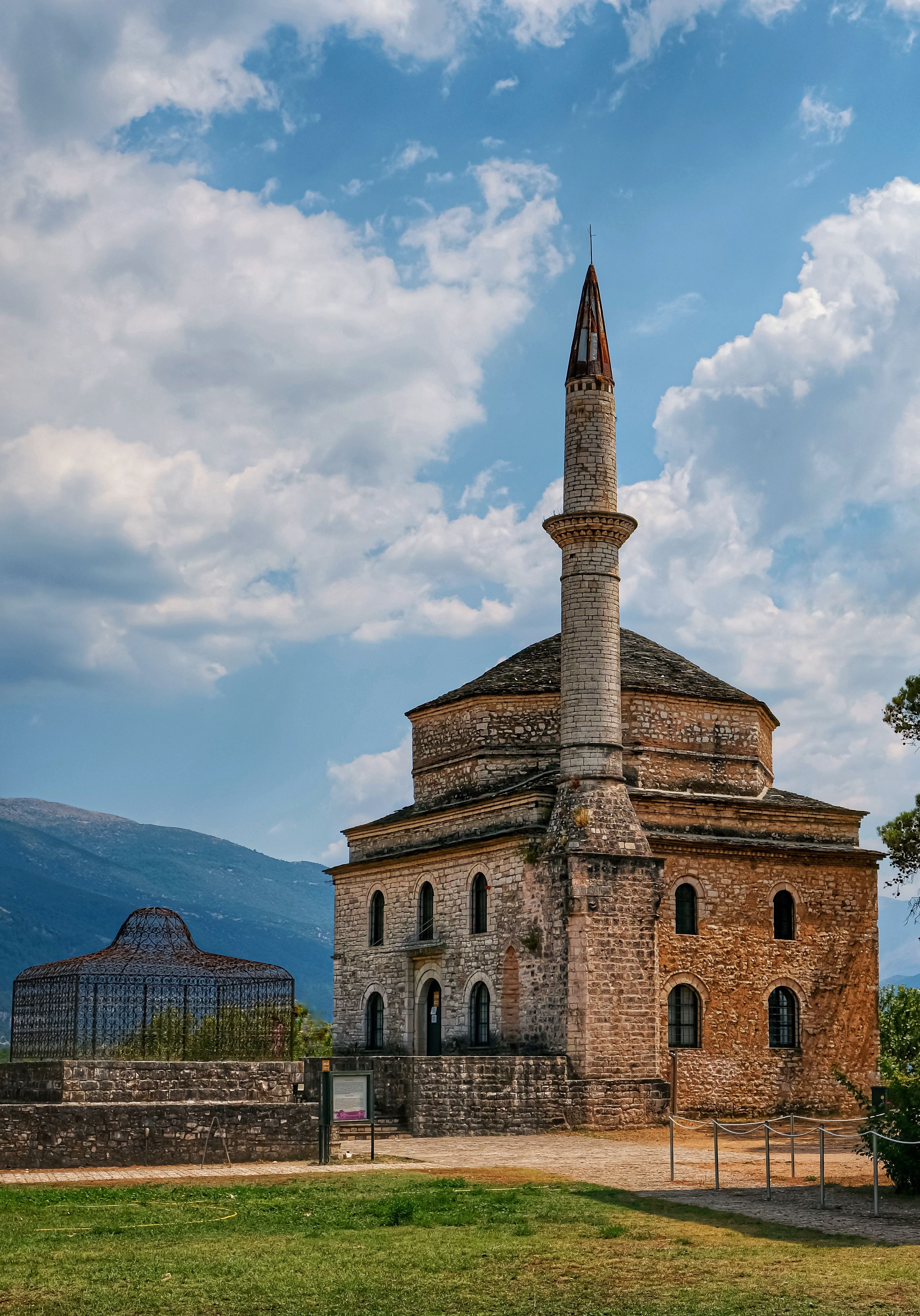 Explore the historic Aslan Pasha Mosque with a stunning outdoor backdrop in Ioannina, Greece.