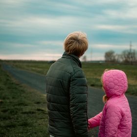 Raising Ravens cover art — a father and daughter walking a rural path. Photo by Alexander Zvir on Pexels.