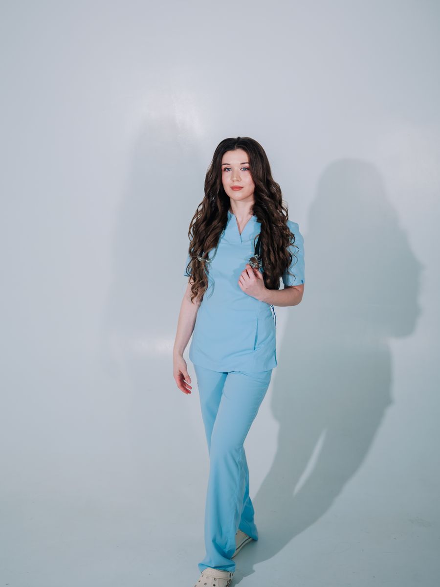 Female medical professional wearing moss scrubs