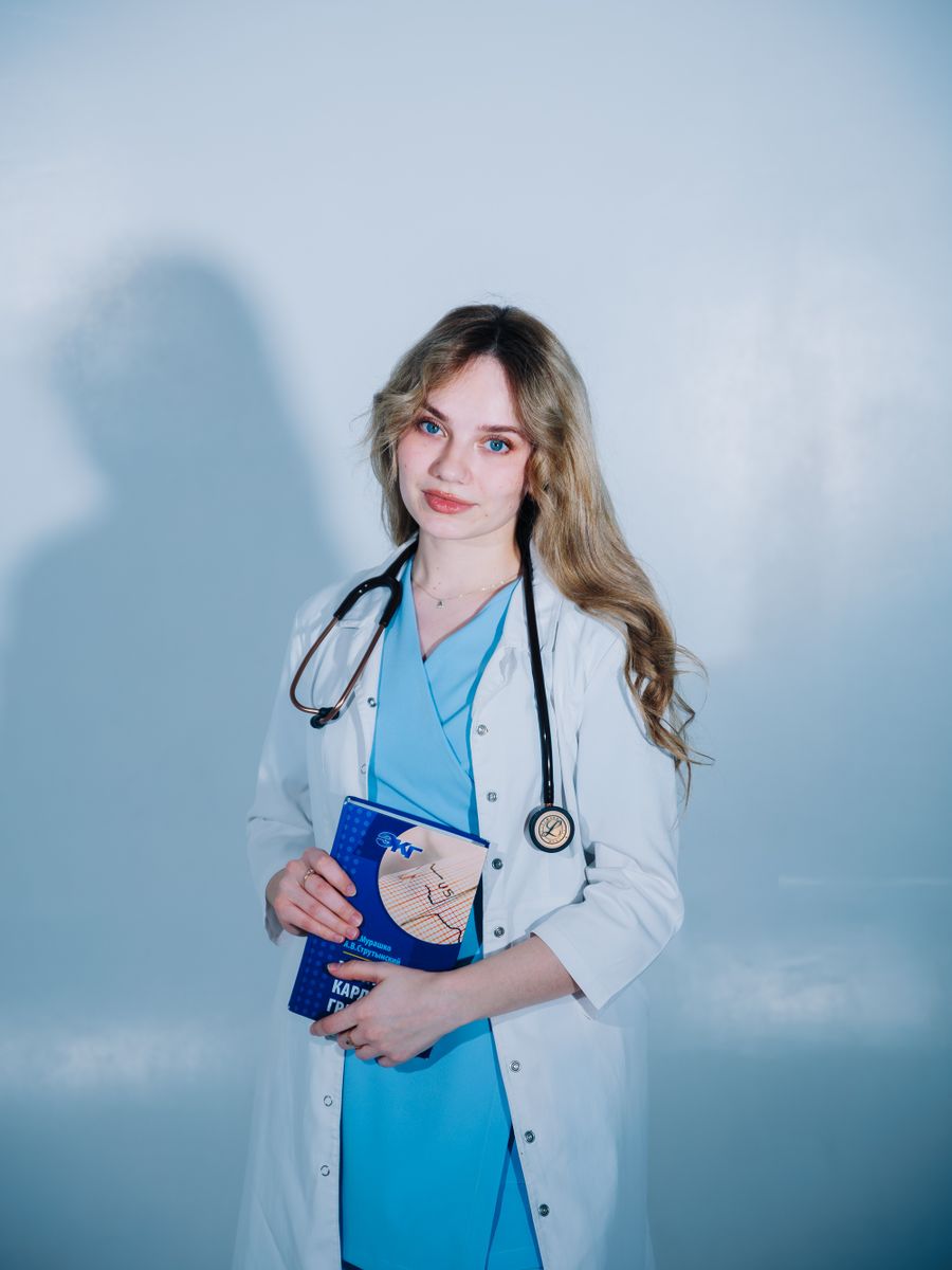 Female medical professional wearing midnight navy scrubs