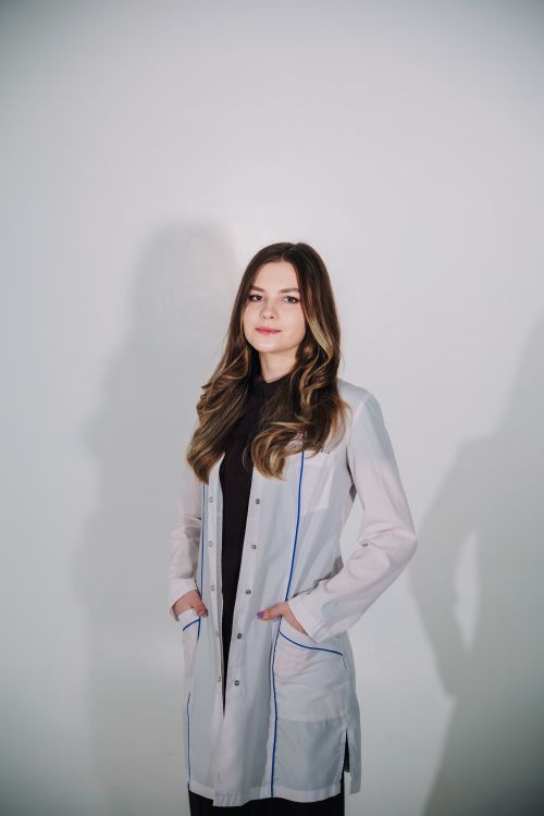 Free A confident female scientist poses in a lab coat, showcasing professional attire and determination. Stock Photo