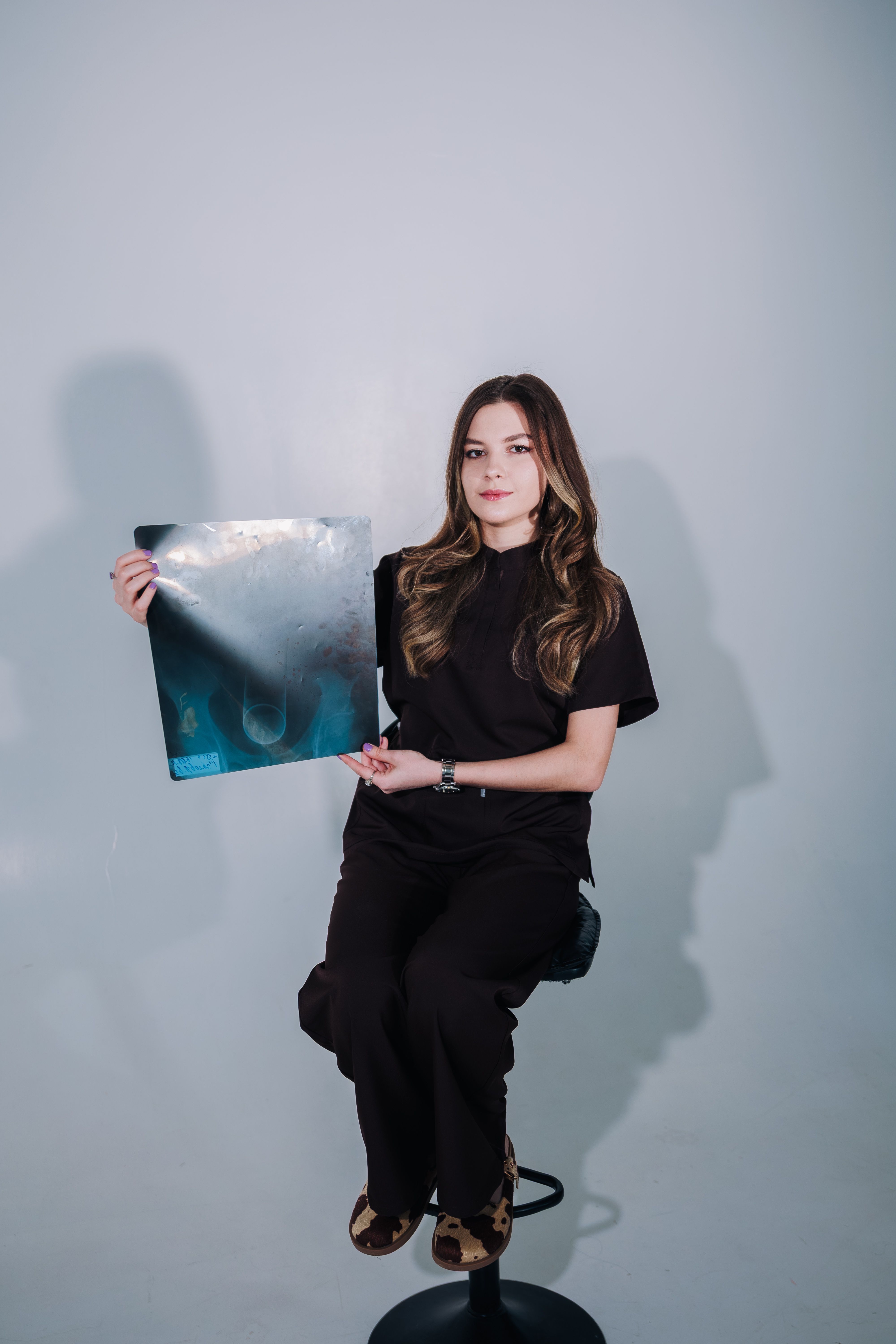Healthcare professional showcasing an X-ray scan for medical analysis.
