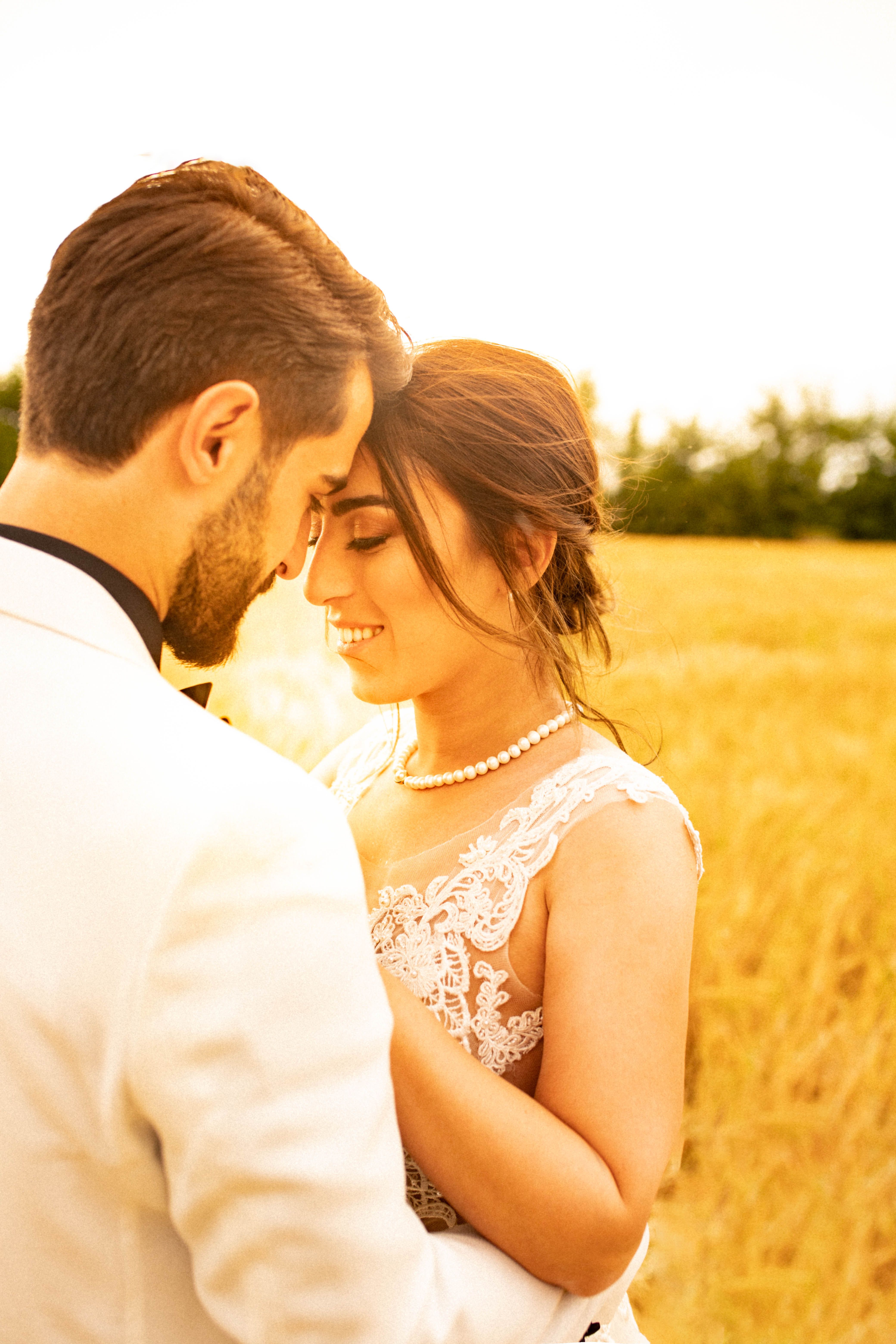 A couple photographed outdoors in soft evening light
