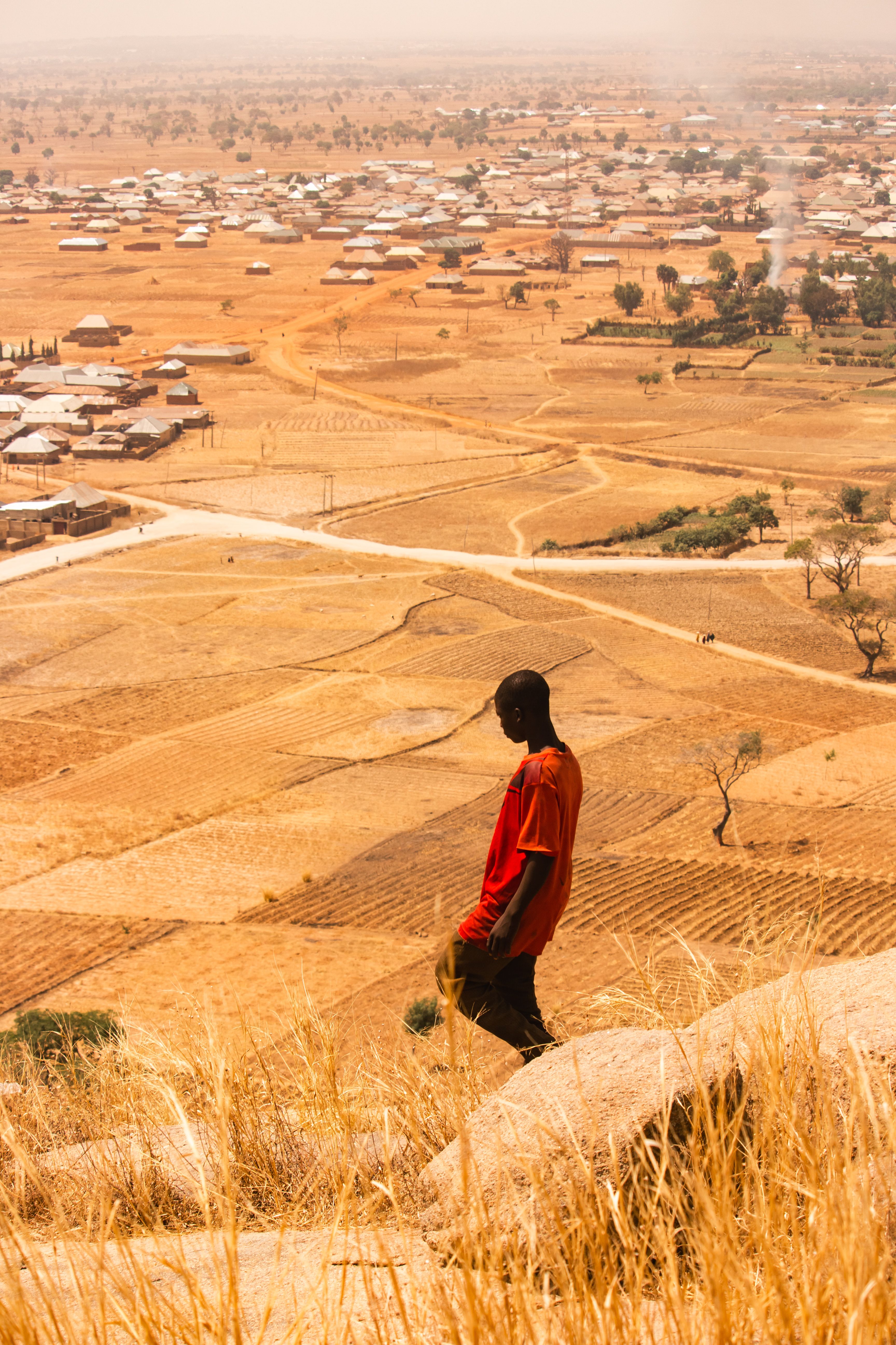 Man Overlooks Expansive African Rural Landscape · Free Stock Photo