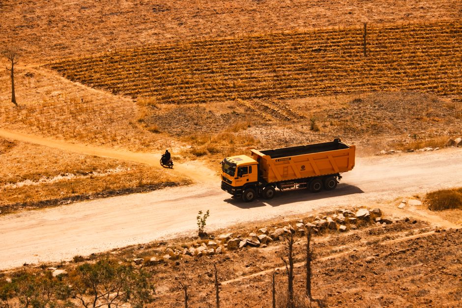 A car driving safely on a well-maintained road in the Jordanian desert