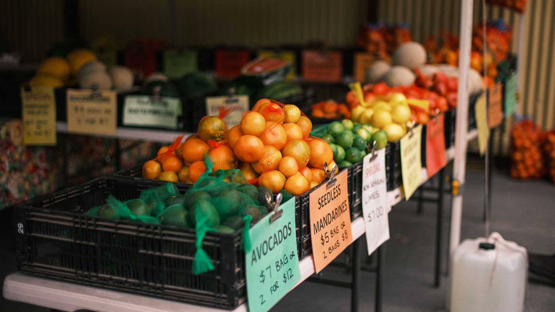 Colorful fruit stand showcasing citrus and other produce at a local farmers market.