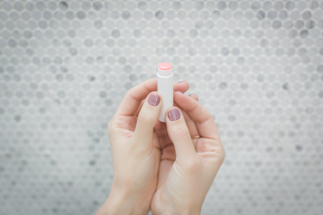 Free Person Holding a lip balm Stock Photo