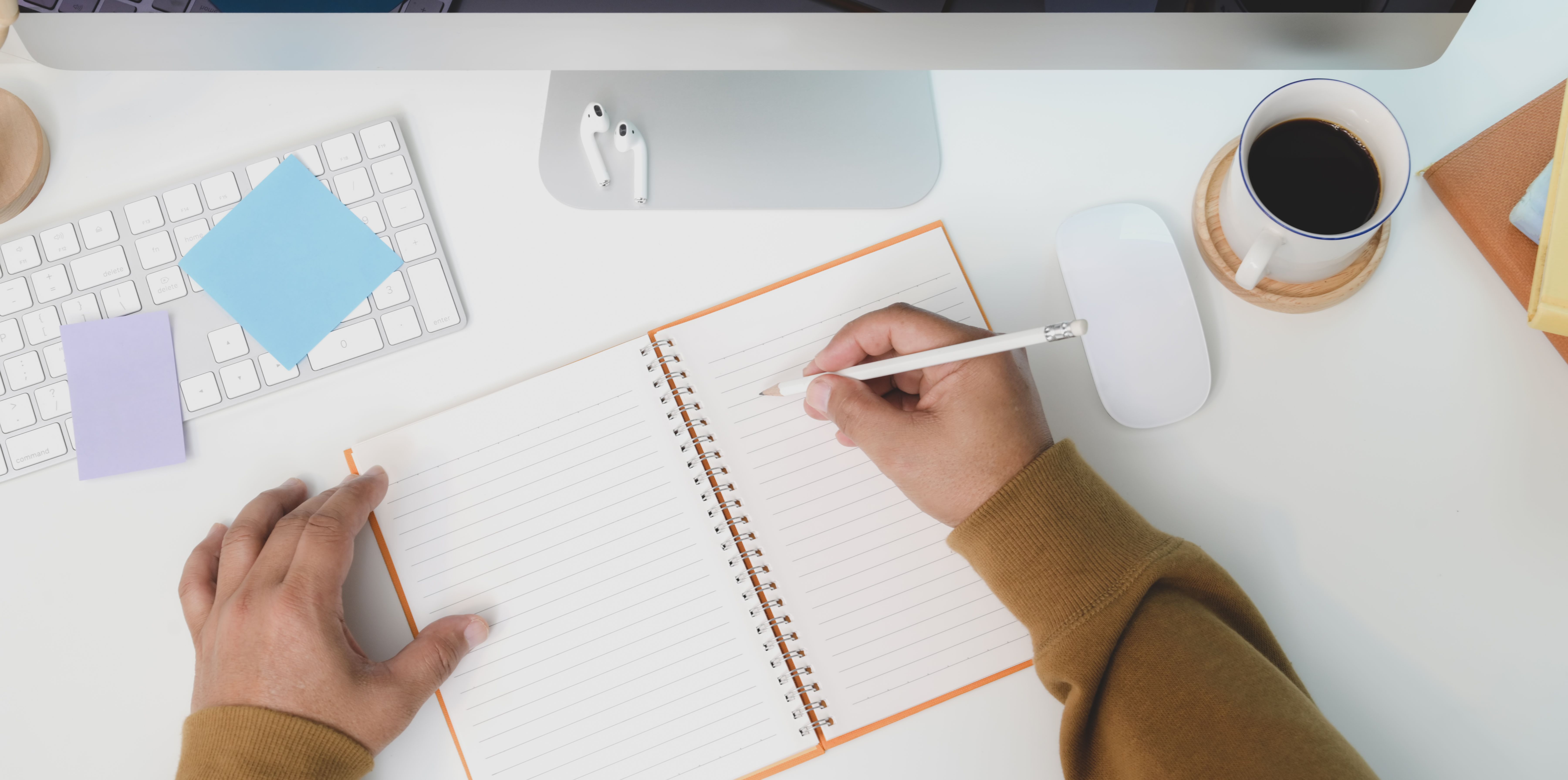 Man Taking Notes at Desk · Free Stock Photo