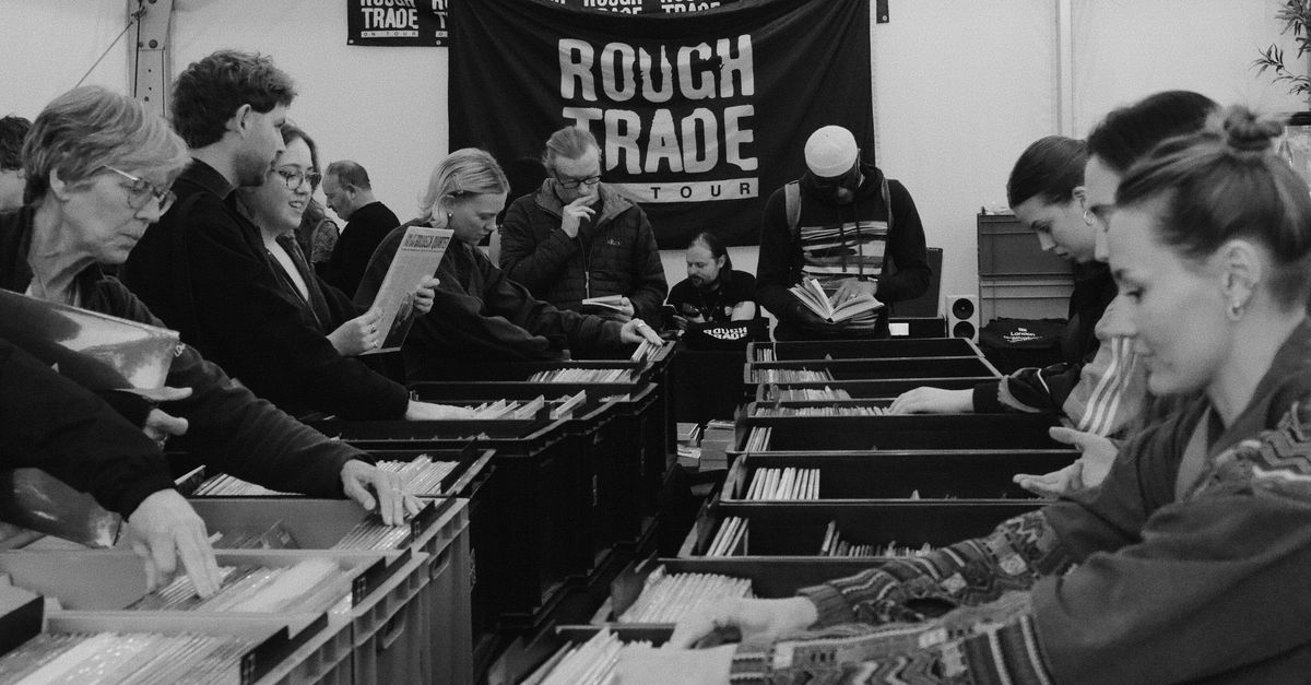 vinyl record store bins being flipped through by young collectors