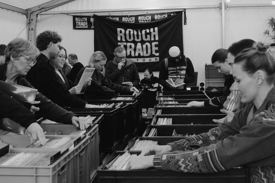 People exploring vinyl records at Rough Trade event in Cheltenham.