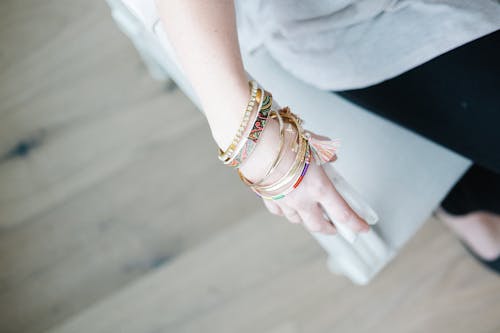 Free Selective Focus Photo of Person's Hand With Gold-bangles Stock Photo