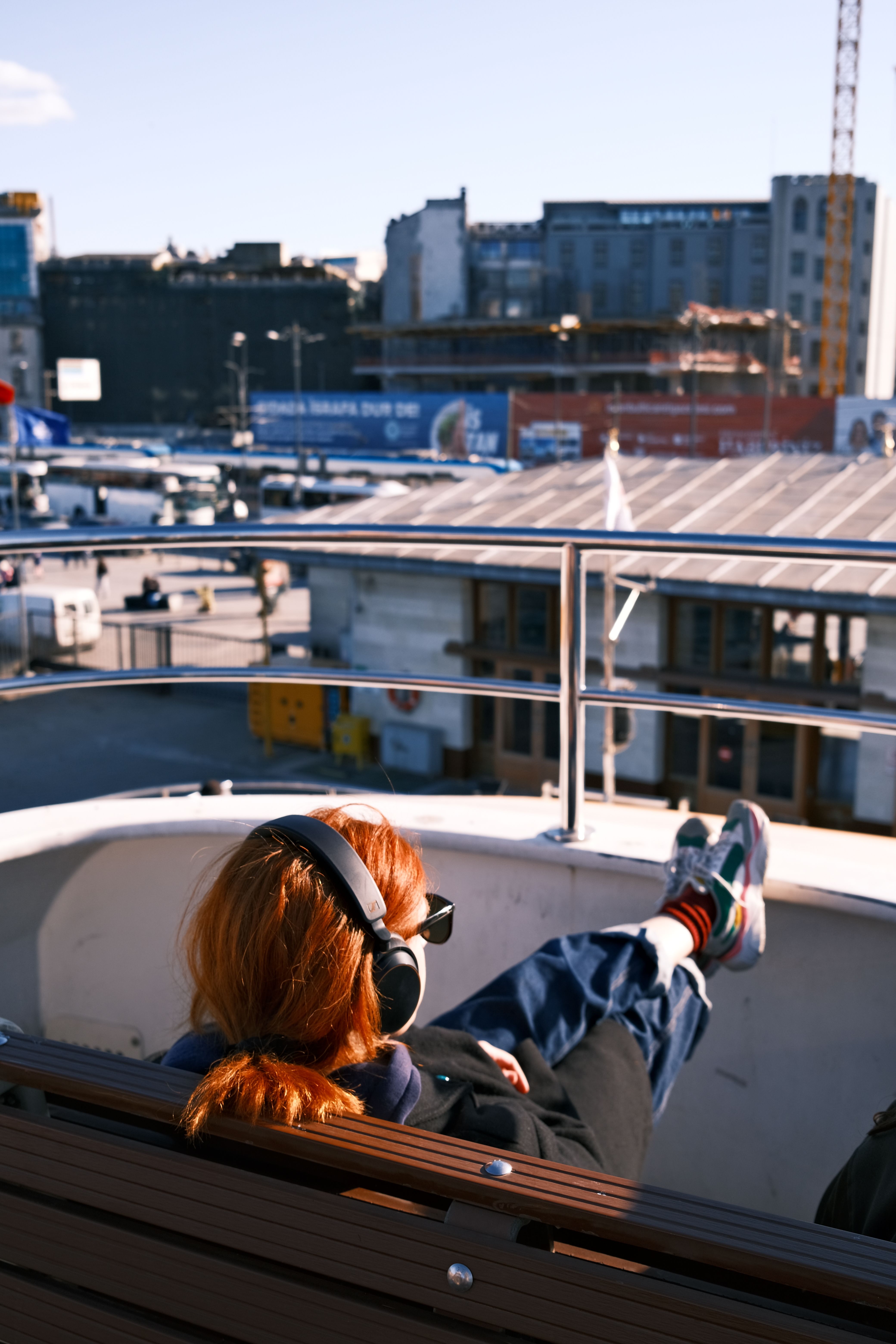 Woman Relaxing on a Ferry Deck with Headphones · Free Stock Photo