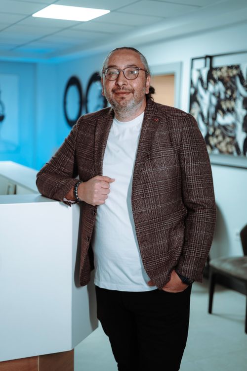 Free A confident man standing in an indoor office with modern decor. Stock Photo