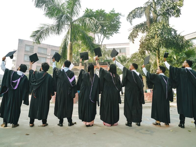Indian graduates celebrating in gowns and caps