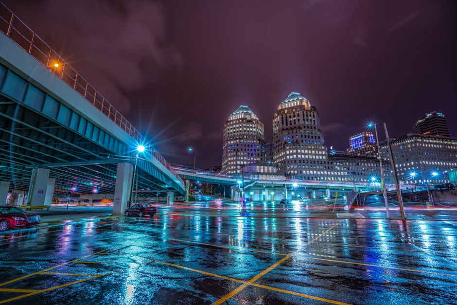 Long exposure of Cincinnati skyline reflecting on wet streets at night. Long exposure of Cincinnati skyline reflecting on wet streets at night.
