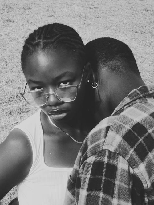 Free Emotive black and white portrait of two young adults in an outdoor setting. Stock Photo