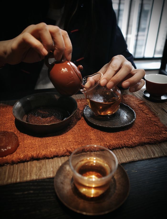 A traditional tea ceremony with an Asian ceramic teapot