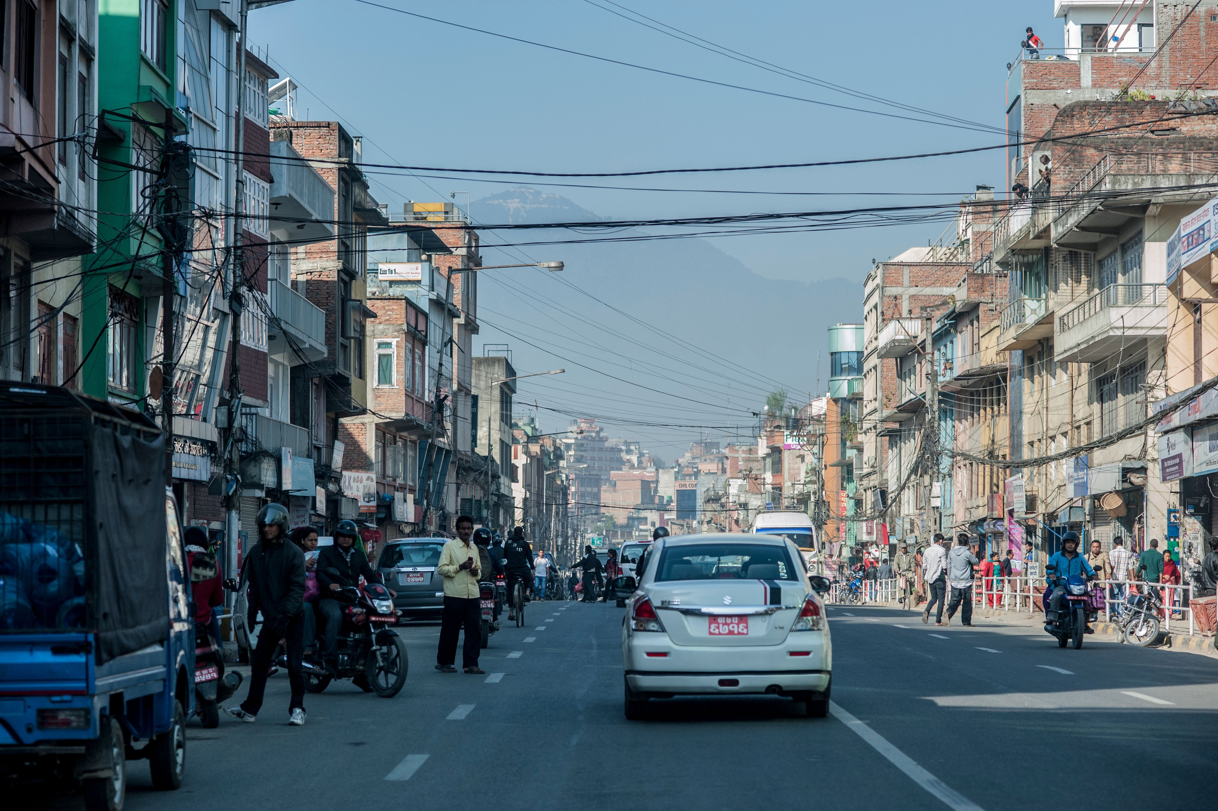 Vibrant street life scene from Kathmandu, Nepal showcasing bustling activities and local architecture.
